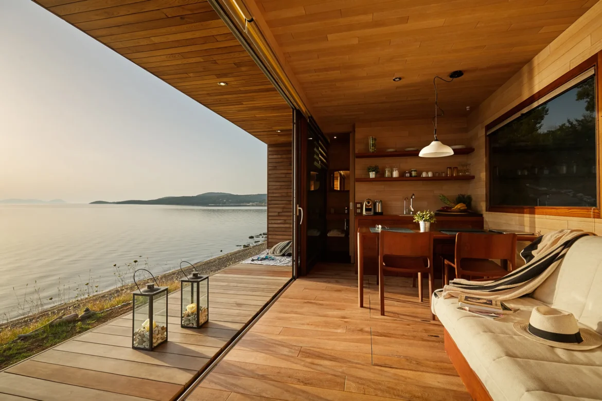 Airbnb Feature a room with a table and chairs and a large window overlooking a body of water