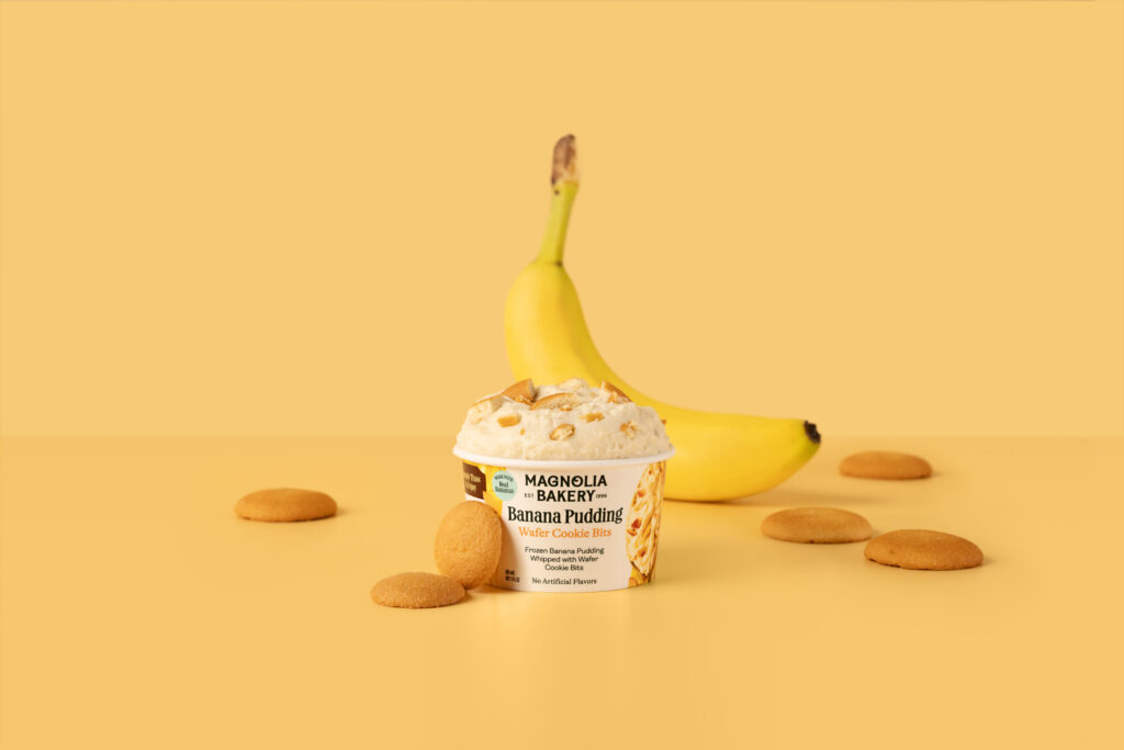 a banana next to a cup of ice cream and cookies