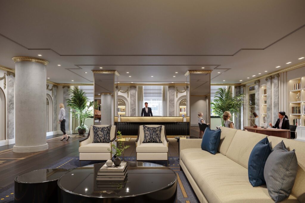 a lobby with a man standing behind a reception desk