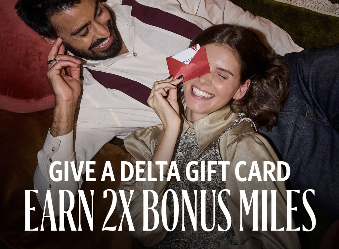 a man and woman lying on the ground holding a red envelope