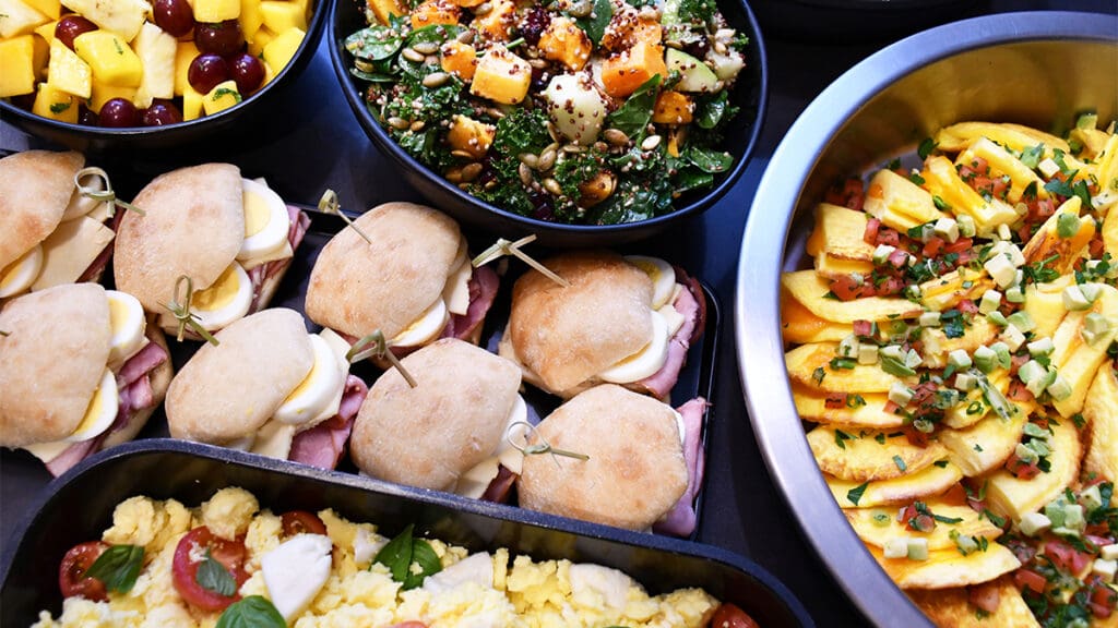 a tray of food with sandwiches and salad