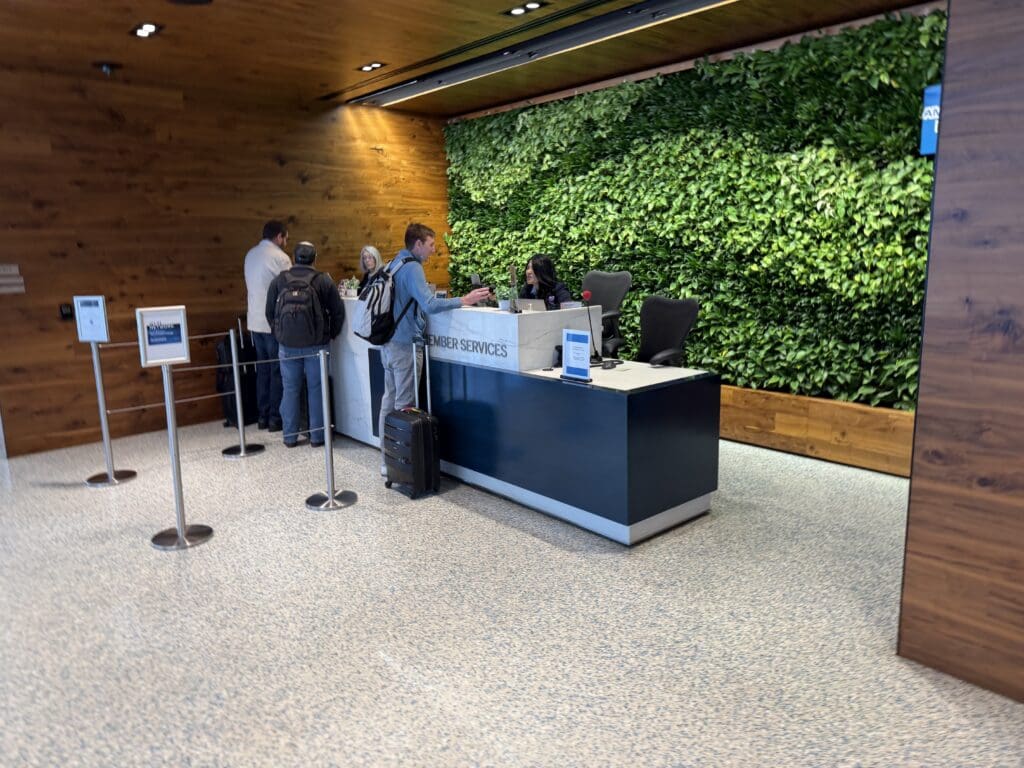 people standing in front of a green wall