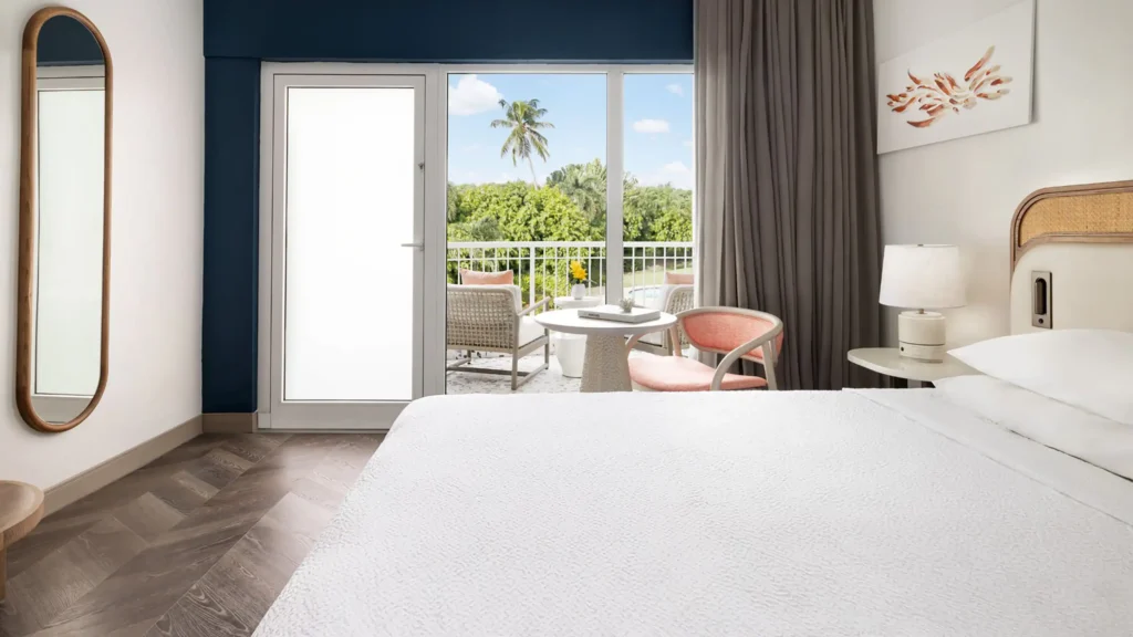 a room with a bed and chairs and a table